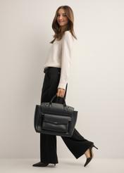 Black women's business briefcase TOREC-1280-99(Z26), front view of the product on a model. Full body view.