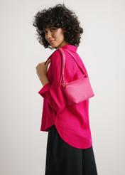 Small fuchsia women's handbag TOREC-0882-5E(W26) - front view of the product, on a model, against a light background. Half-length silhouette visible.