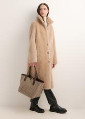 Reversible women's handbag with monogram TOREN-0359-1B(Z26); front view of the product held in a model's hand.