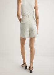 Light beige women's linen shorts SZODT-0016-1A(W26), back view of the product on the model. Half of the silhouette visible.
