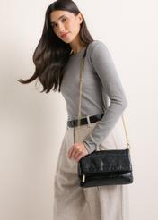 Black women's handbag with chain TOREC-1335-9F(Z26), front view of the product on a model. Half of the silhouette visible.