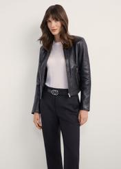 Women's black short leather jacket KURDS-0294-99(KS), front view of the product on the model. Half of the silhouette visible.