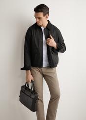 Black leather men's bag TORMS-0524-99(Z26), diagonal view of the product on the model. Half of the silhouette visible.