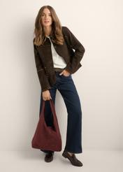 Burgundy suede shopper bag TORES-1403-4D(Z26) - view of the product held in the model's hand, against a light background. The entire silhouette is visible.