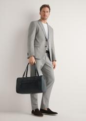 Men's black leather travel bag TORMS-0500-99(W26), product view in model's hand. Full body visible.