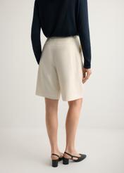 Women's cream wool shorts SZODT-0021-0B(W26), back view of the product on the model. Half of the silhouette visible.