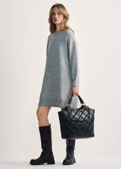 Black quilted women's handbag TOREC-1057-99(Z25), product view from the front on the model, the entire silhouette is visible.