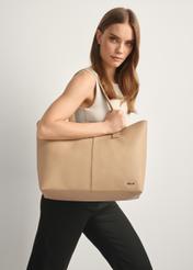 Beige women's shopper bag TOREC-1208-1A(W26), front view of the product on a model, half of the silhouette visible.