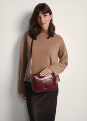 Burgundy women's handbag TOREC-0003J-49(Z25), front view of the product on a model, half of the silhouette visible.