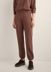 Brown women's trousers SPODT-0117-1H(Z26), front view of the product on the model. Half of the silhouette visible.