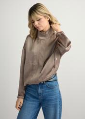 Light beige women's bomber jacket KURDT-0627-1K(W26) - front view of the product, on a model, against a light background. Half-length silhouette visible.