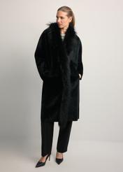 Black leather double-sided women's sheepskin coat KOZDS-0093-1396(Z25), front view of the product on the model. Full body visible.