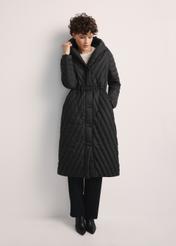 Women's long jacket with quilting KURDT-0523-98(Z25), front view of the product on the model, the entire silhouette is visible.