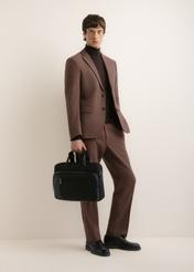 Black men's laptop bag TORMN-0443-99(Z26); front view of the product held in a model's hand, with the model's full figure visible.