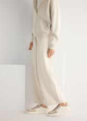 Women's leather sneakers in cream color BUTYD-1260-0B(W26), product view from the side on the model, half of the silhouette visible.