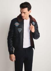 Men's brown aviator-style sheepskin coat KOZMP-0007-1I(Z26) - front view of the product modeled against a white background. Knee-length silhouette visible.