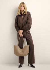 Beige women's shopper bag TOREC-1296-1B (Z26), view of the product in the model's hand. Full body visible.