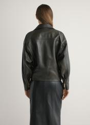 Women's oversize brown leather biker jacket KURDS-0608-1I(W26), back view of the product on the model. Half of the silhouette visible.