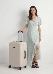 Large suitcase on wheels WALAB-0040-0C-28(W26), product view diagonally next to the model, the entire silhouette is visible.