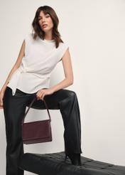 Women's leather handbag in burgundy color TORES-1189-49(Z25), view of the product in the model's hand on a light background.