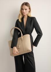 Beige women's shopper bag TOREC-1241-1B(Z26), front view on model. Half of the silhouette visible.