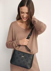 Black women's handbag with monogram TOREC-1159-9P(W26), front view of the product on a model, half of the silhouette visible.