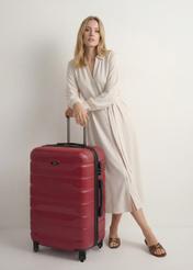 Large suitcase on wheels WALAB-0067-49-28(W25), product view diagonally next to the model, the entire silhouette is visible.