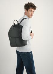 Large men's leather backpack TORMS-0493-99(W26) - slightly diagonal view of the product, on a model, against a light background. Half of the silhouette is visible.