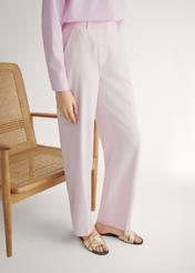 Women's gold braided flip-flops BUTYD-0903C-2X(W26), side view of the product on the model's feet.