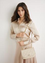 Cream patent leather women's handbag TORES-1297-0B(W26), front view of the product on a model. Knee-length silhouette visible.