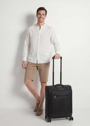 Small suitcase on wheels WALNY-0046-99-19(W26), diagonal view of the product next to the model's silhouette.