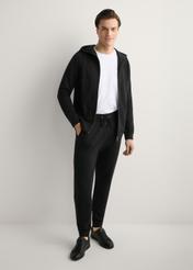 Men's black sweatpants SPOMT-0017-99(W26), product view from the front on the model, the entire silhouette is visible.