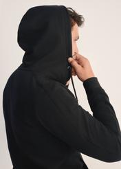 Men's black hooded sweatshirt BLZMT-0074-99(Z25), close-up of the hood on the model. Upper body visible.