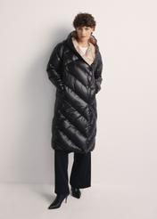 Long black women's winter jacket KURDT-0542A-98(Z25), product view from the front on the model, the whole silhouette is visible.