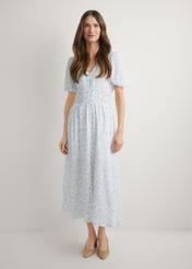 Long floral dress in white SUKDT-0191-7P(W26), front view of the product on the model. Full body visible.