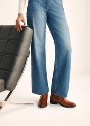 Women's leather ankle boots in cognac color BUTYD-0936A-87(Z25), view of the product on the model's feet against a light background.