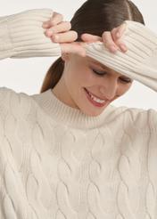 Light beige women's sweater with decorative weave SWEDT-0210-80(Z25), close-up of the product detail on the model.