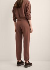 Brown women's trousers SPODT-0117-1H(Z26), product view from the back on the model. Half of the silhouette visible.
