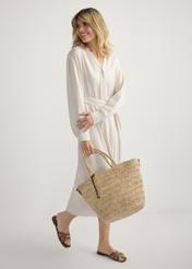 Women's straw shopper bag TOREC-0939-1E(W26), front view of the product in the hands of a model against a light background. Full body visible.