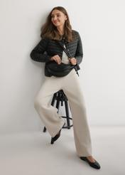 Black semi-circular women's handbag TOREC-1146-99(W26), product view on model's shoulder. Full body visible.