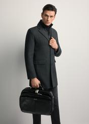 Black leather men's laptop bag TORMS-0482-99(Z25) - front view of the product, held by the model. Full body visible.