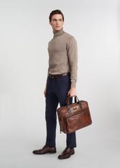 Brown leather men's bag TORMS-0100-1H(W26), product view in model's hand, against a light background. Full body visible.