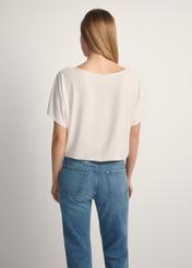 Women's white ribbed blouse BLUDT-0170-0B(W26), back view of the product on the model. Half of the silhouette visible.