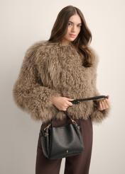 Black women's shoulder bag TOREC-1345-9I(Z26), diagonal view of the product on the model. Half of the silhouette visible.