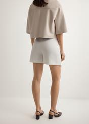 Women's white culottes SZODT-0008-0B(W26), back view of the product on the model. Half of the silhouette visible.