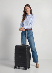 Medium suitcase on wheels WALPP-0024-99-24(W26), product view from the front with the model, the whole silhouette visible.