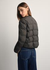 Black women's short jacket KURDT-0621-99(W26), back view of the product on the model. Half of the silhouette visible.