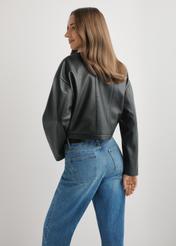 Women's short black leather jacket KURDS-0597-99(W26), back view of the product on the model. Half of the silhouette visible.