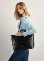 Black women's shopper bag TOREC-1204-9G(W26), product view on model's shoulder. Half of silhouette visible.