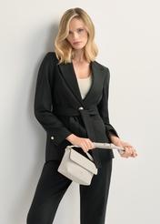 Cream small women's shoulder bag TOREC-0916-0B(W26), front view of the product in the model's hand. Half of the silhouette visible.